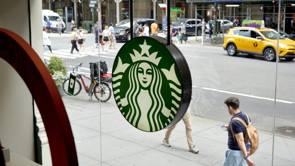 A U.S. flag flying above the Starbucks headquarters at Starbucks Center in Seattle, Washington, captured in an aerial view.