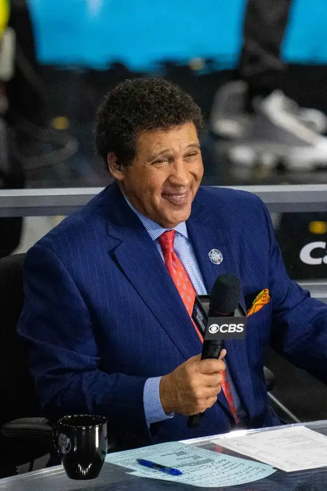 Greg Gumbel, trailblazing sports broadcaster, speaking during a live event.

